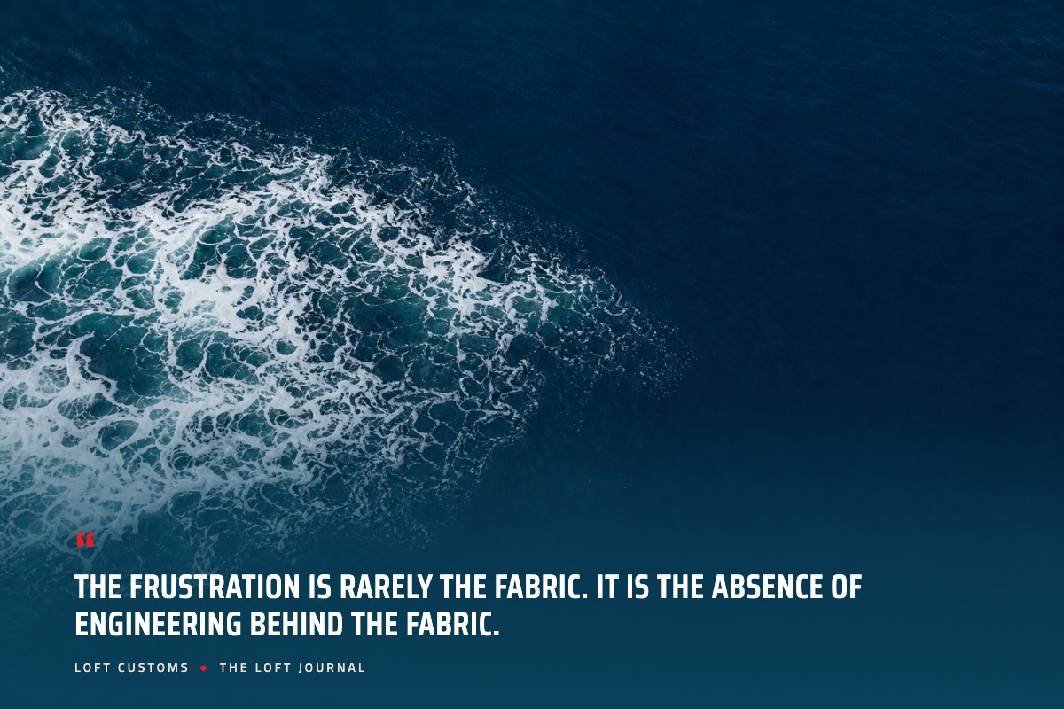 Pull quote over aerial ocean water: The frustration is rarely the fabric. It is the absence of engineering behind the fabric. Loft Customs, The Loft Journal