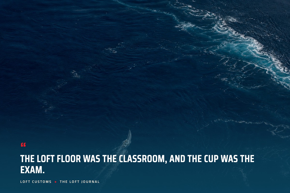 Pull quote over aerial ocean water: The loft floor was the classroom, and the Cup was the exam. Loft Customs, The Loft Journal