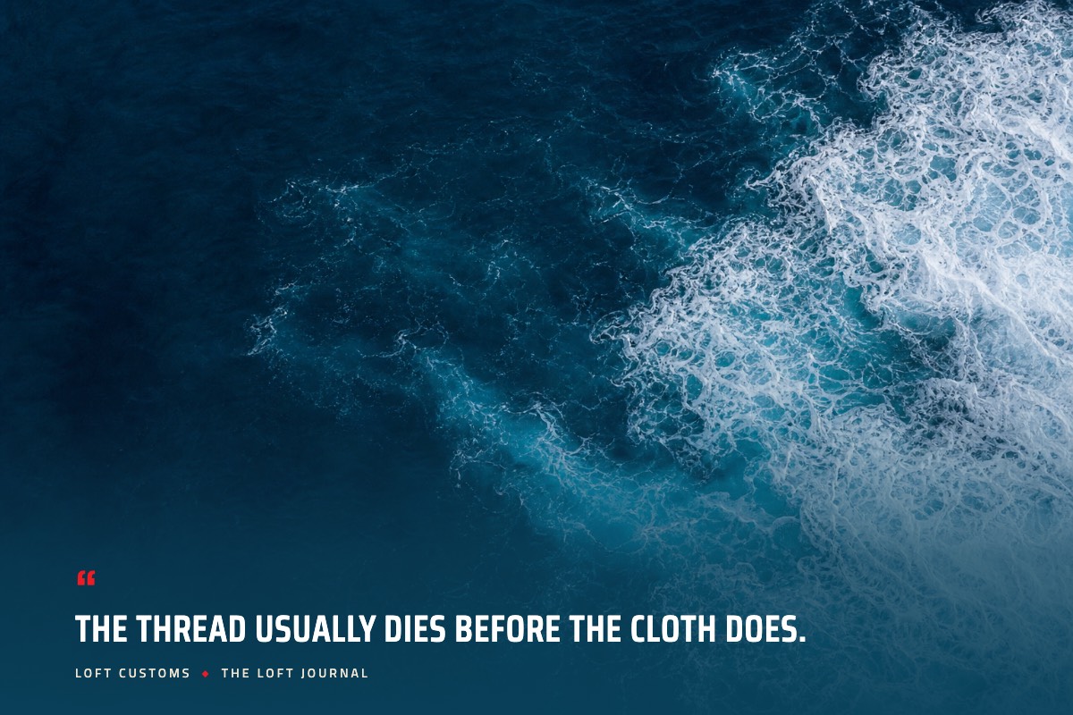 Pull quote over aerial ocean water: The thread usually dies before the cloth does. Loft Customs, The Loft Journal
